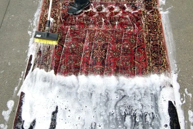 Spazzolatura manuale di un tappeto durante il lavaggio